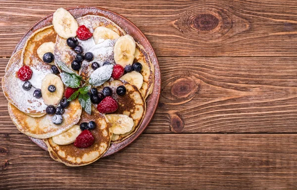 Pannenkoeken met vers fruit voor het ontbijt, bovenaanzicht. — Stockfoto