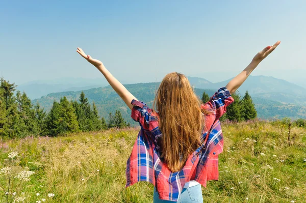 Jovem mulher olhando para um céu na montanha . — Fotografia de Stock