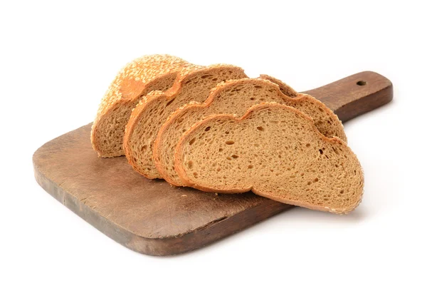 Skivat bröd på en skärbräda isolerad på vitt — Stockfoto