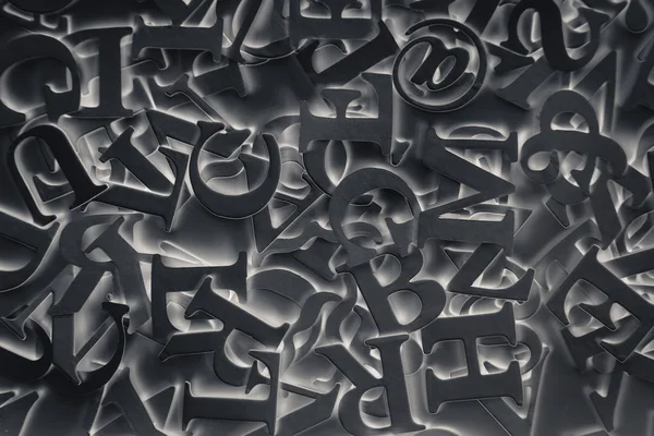 Абстрактний фон з чорними літерами — стокове фото