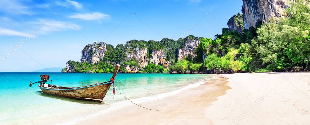 Panorama of thai traditional wooden longtail boat and beautiful sand Railay Beach in Krabi province. Ao Nang, Thailand. 