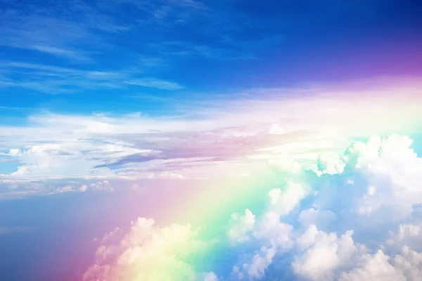 Blue sky with clouds and a rainbow — Stock Photo, Image