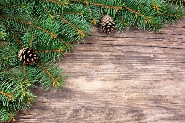 Christmas fir tree on a wooden background — Stock Photo, Image