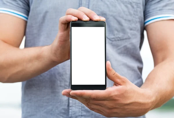 Young man showing a mobile phone application — Stock Photo, Image