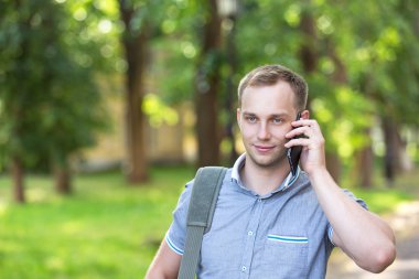 Bir akıllı telefon kullanan genç adam 