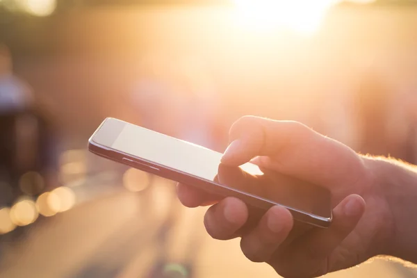 Man using his Mobile Phone outdoor