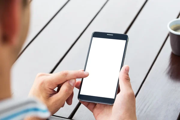 Man holding smart mobile phone on wooden table — Stock Photo, Image