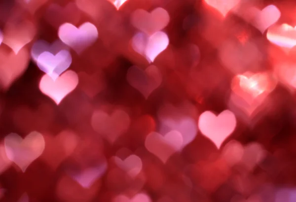 Abstracte roze achtergrond met hart-vormige boke — Stockfoto