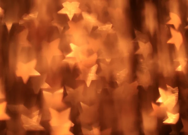 Праздничный золотой фон со звездообразным боке — стоковое фото