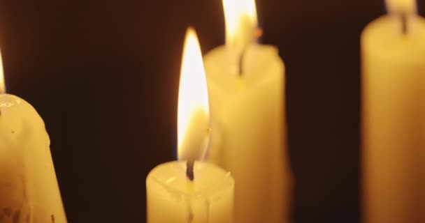 Świece świecące na ciemnym tle — Wideo stockowe