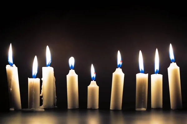 Candles glowing against dark background — Stock Photo, Image