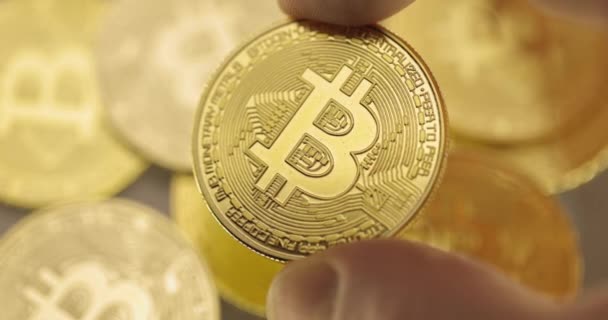 Inspecting Physical Bitcoin Held Hands Closeup — Stock Video