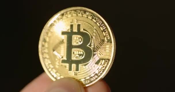 Shiny physical bitcoin in hands over sunlight — Stock Video