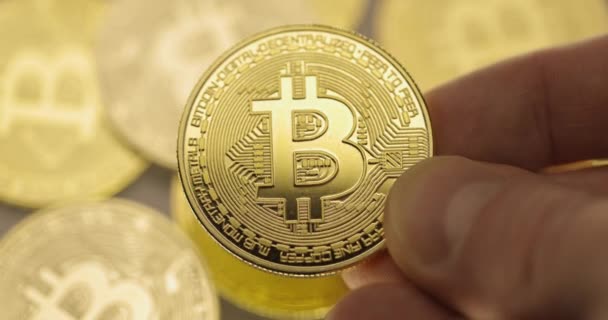 Inspecting Physical bitcoin held in hands closeup — Stock Video