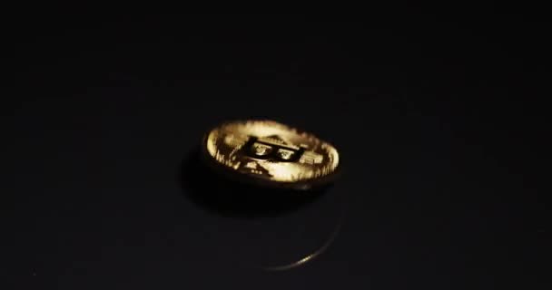 Shiny bitcoin spinning around on steel surface slow motion 120 fps — Stock Video