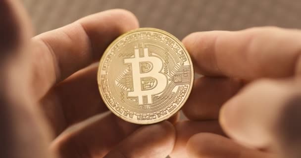 Inspecting Physical Bitcoin Held Hands Closeup — Stock Video