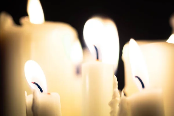 Candles glowing against dark background — Stock Photo, Image