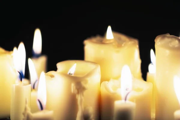 Candles glowing against dark background — Stock Photo, Image