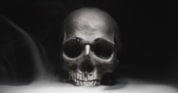 Tengkorak hitam dalam kegelapan dengan asap dan kabut — Stok Video