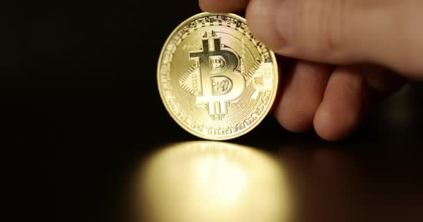 Shiny physical bitcoin in hands over sunlight — Stock Video