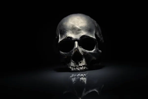 Spooky dark black skull aginast dark background — Stock Photo, Image