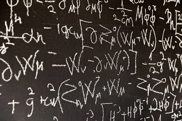 Mathematical formulas on dark black chalk board — Stock Photo, Image