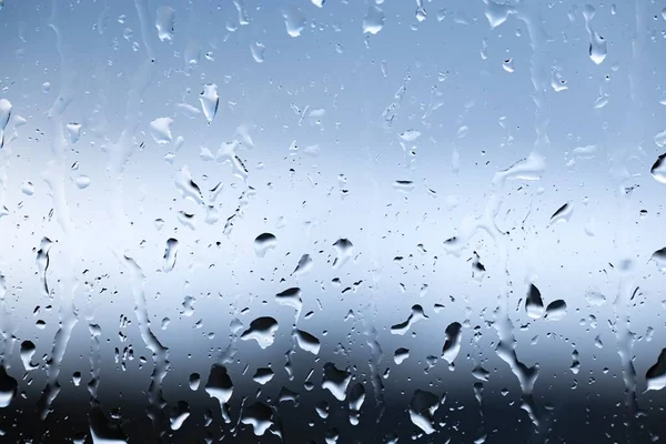 Streams of raindrops on window glass — Stock Photo, Image