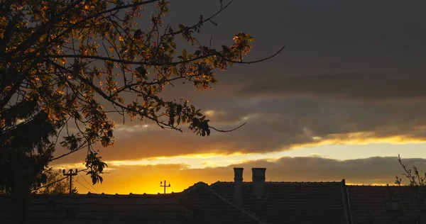 Suburban scene with sunset and dramatic sky — Stock Photo, Image