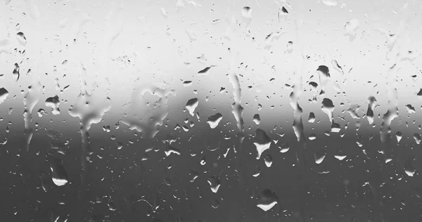 Streams of raindrops on window glass — Stock Photo, Image