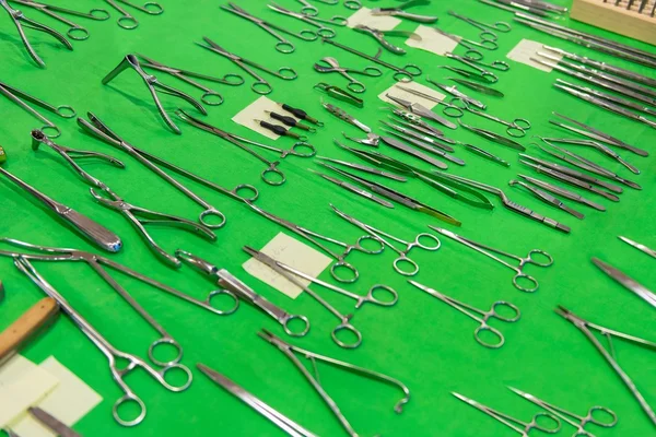 Medical instruments collection on green textile — Stock Photo, Image