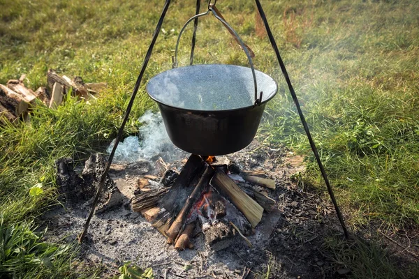 Camp fire outdoors burning with pot — Stock Photo, Image