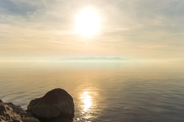 Spiaggia con rocce e cielo nuvoloso — Foto Stock