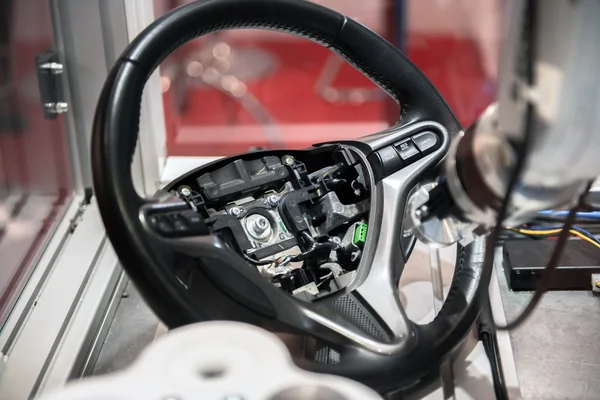 Robotic arm tearing down steering wheel — Stock Photo, Image