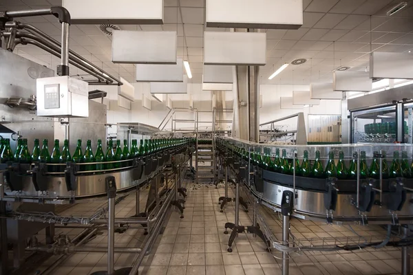 Many bottles on conveyor belt — Stock Photo, Image