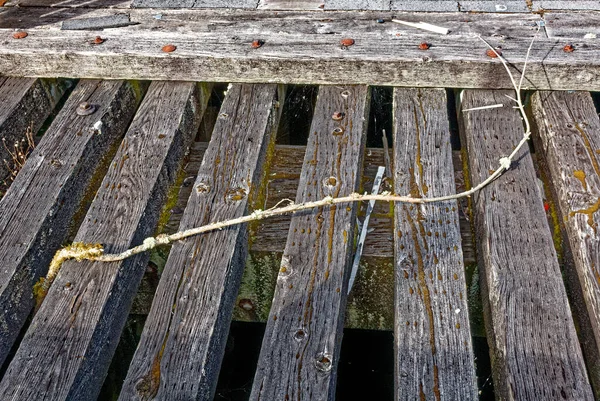 Close up shot of old wooden pier - Old vintage weathered wooden planks of a sea pier as a background