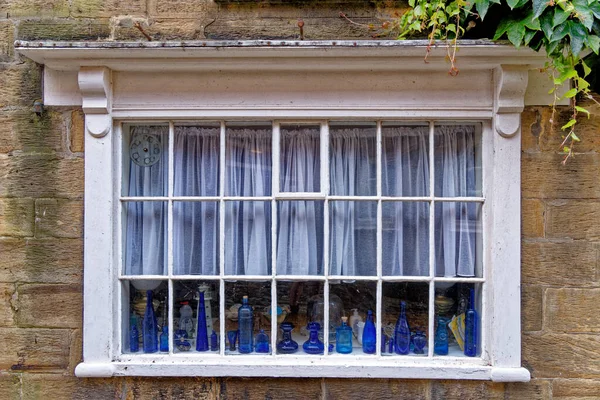 House window in Robin Hood Bay village street scenes. Robin Hood's Bay - small fishing village and a bay in in the North York Moors National Park. North Yorkshire, England