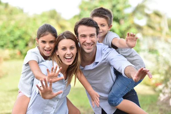 Parents giving piggyback ride — Stock Photo, Image