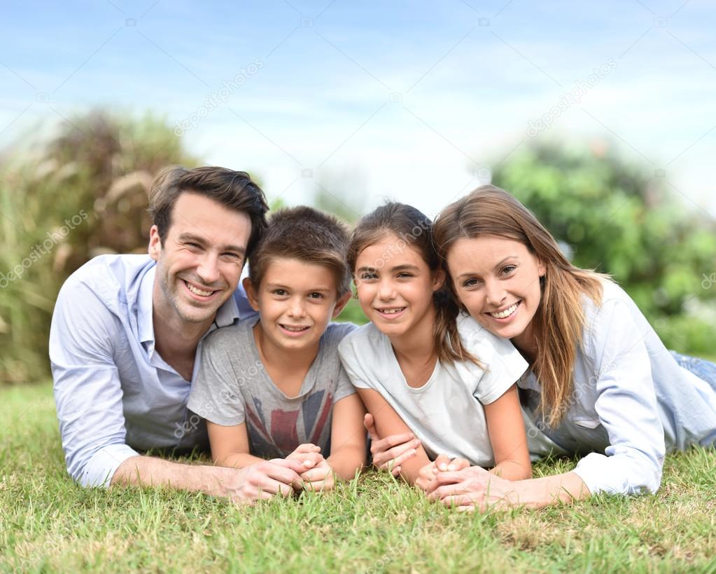 family lying down in grass