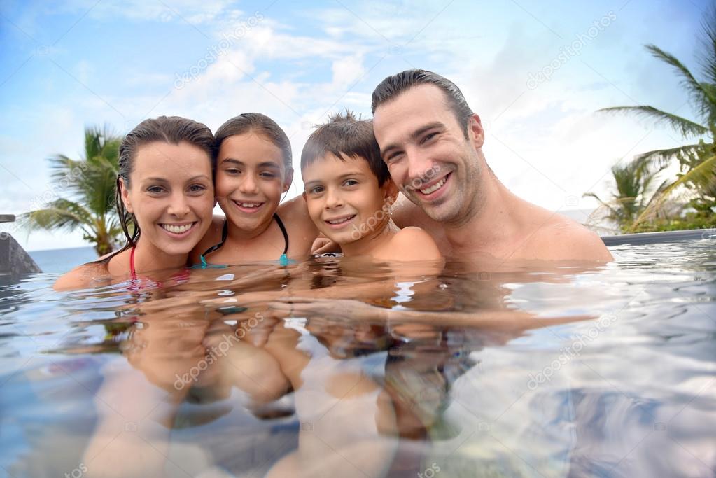 Family enjoying swimming-pool