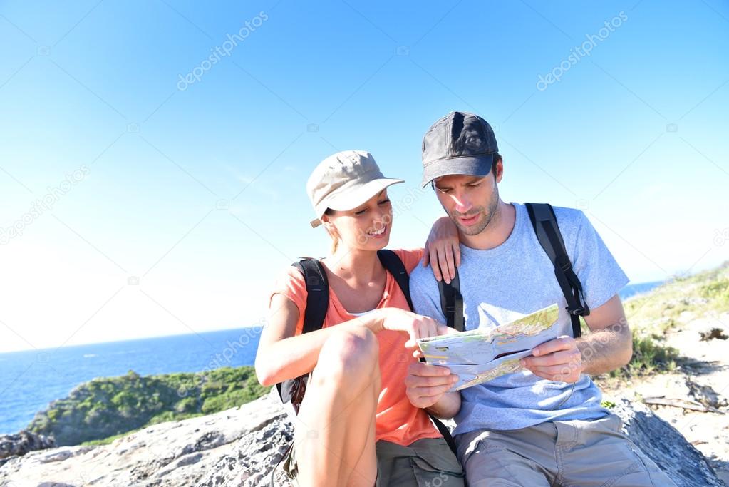 hikers looking at map and scenery