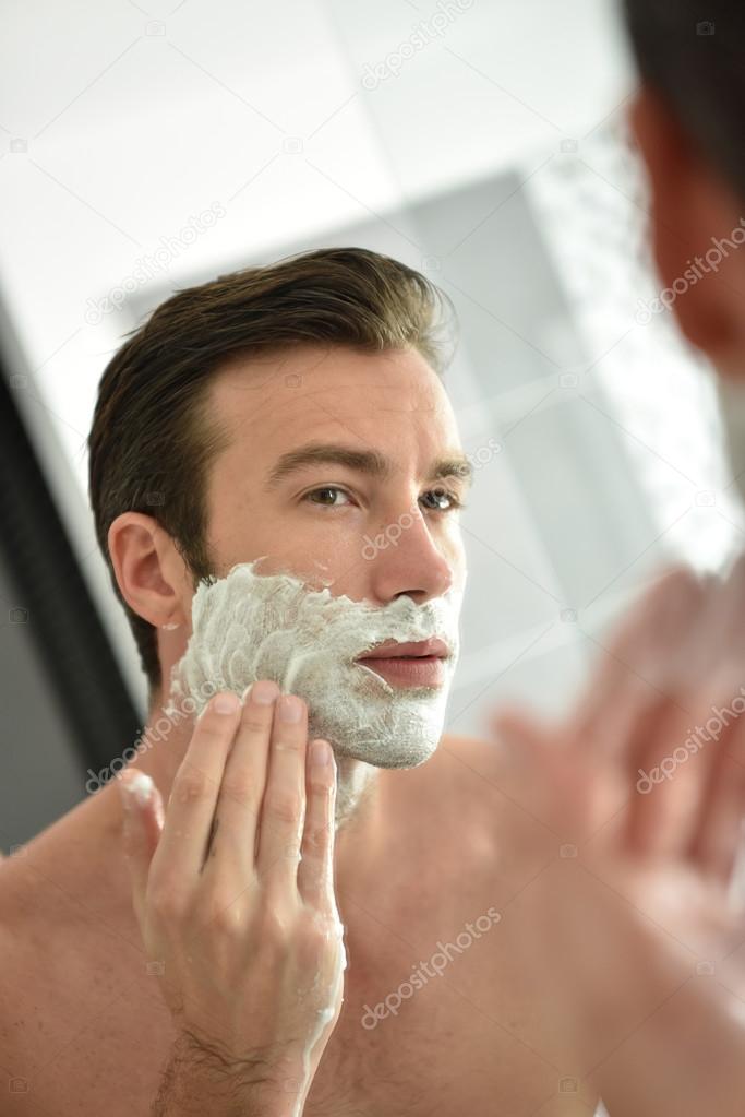 man shaving with foam