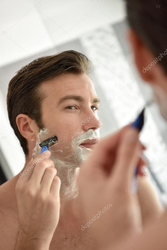 Adult man shaving