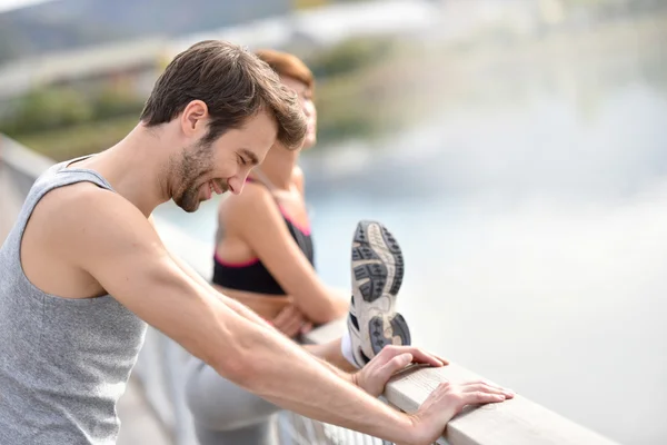 Athletic man stretching out — Stock Photo, Image