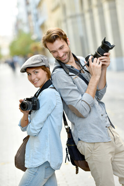 photographers with cameras standing