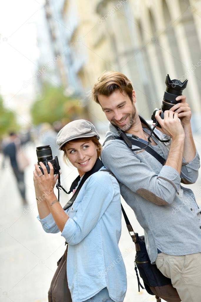 photographers with cameras standing