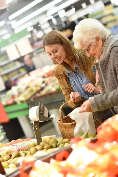 Mulher idosa com mulher jovem compras — Fotografia de Stock