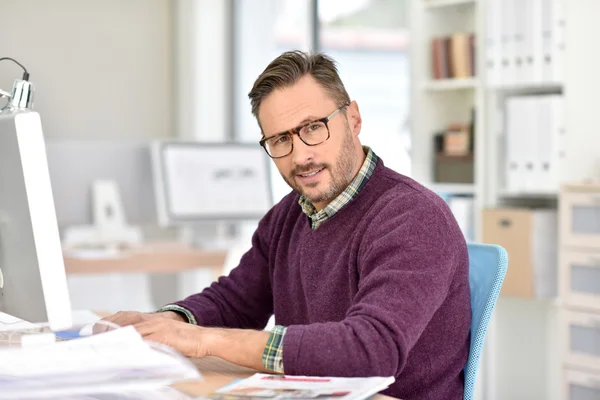 Businessman with eyeglasses on  sitting — Stock Photo, Image