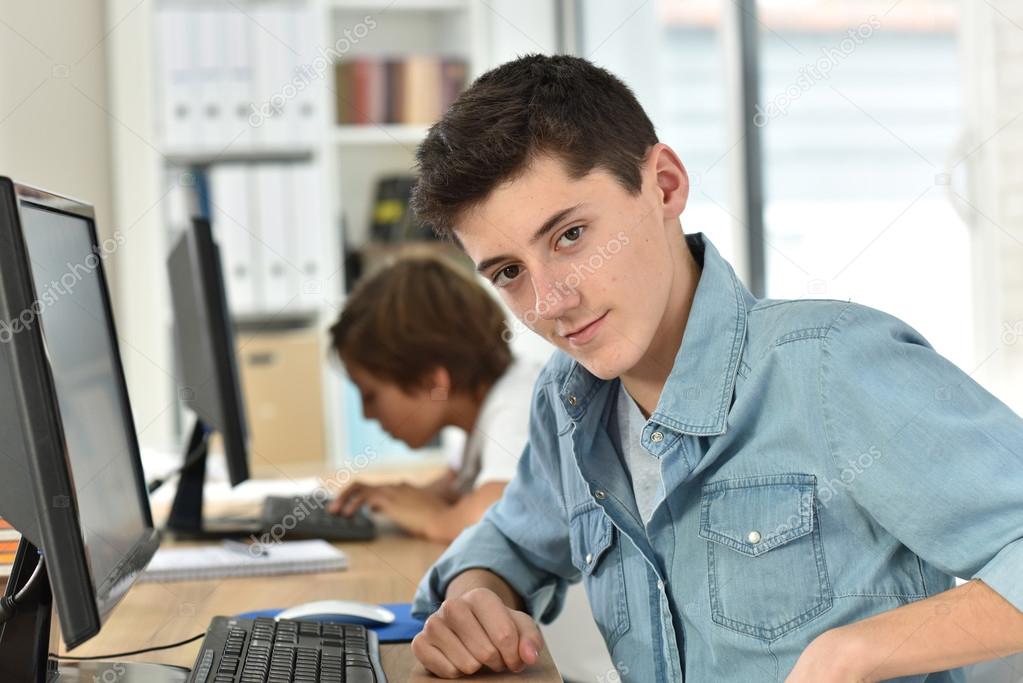 teenager studying on desktop computer