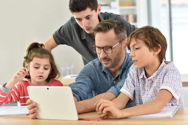 Teacher with students using digital tablet — Stock Photo, Image