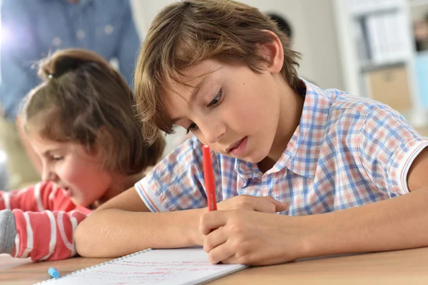 School boy in class writing Royalty Free Stock Images